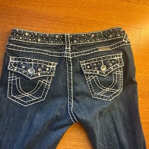 Blue Boot Cut Jeans with Decorative Back Pockets and Rhinestone Embellishments